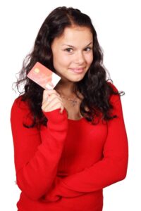 A woman proudly showing her credit card in Bedford, NH