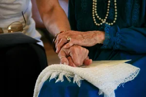 Close-up of two elderly hands gently holding each other in Bedford, NH