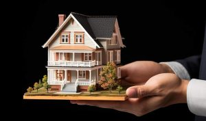 Model home in hands symbolizing real estate investment security in Bedford, NH 