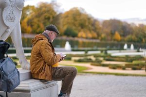 Retired investor managing retirement portfolio on mobile in Bedford, NH
