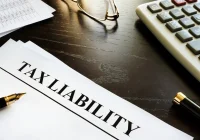 Tax liability document placed on a desk representing financial planning and tax obligations in Bedford, NH